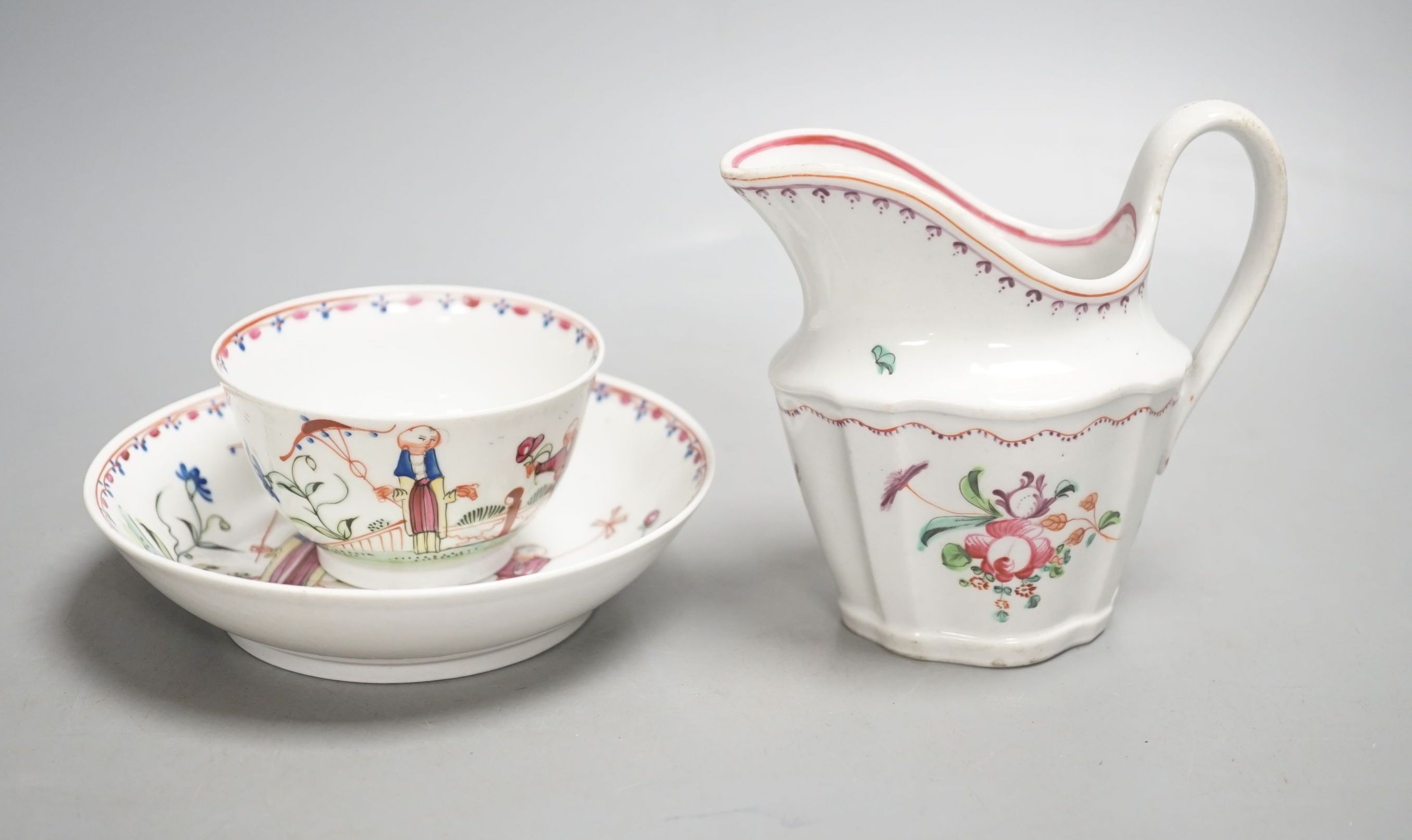 A New Hall teabowl and saucer painted with oriental children with either a pinwheel or a parasol pattern no. 20 and a cream jug painted with flowers pattern 253 C.1785